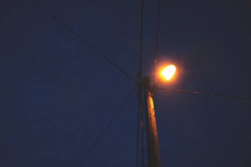 lantern on wooden post at night