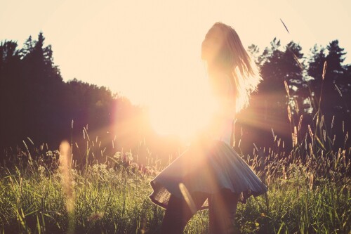 young-woman-standing-in-meadow-at-sunset5e01913d00fa17ab.jpeg